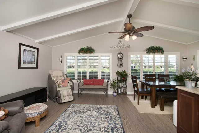 a living room with patio furniture and a large window