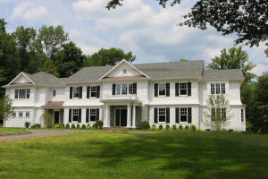 a view of house with yard and green space