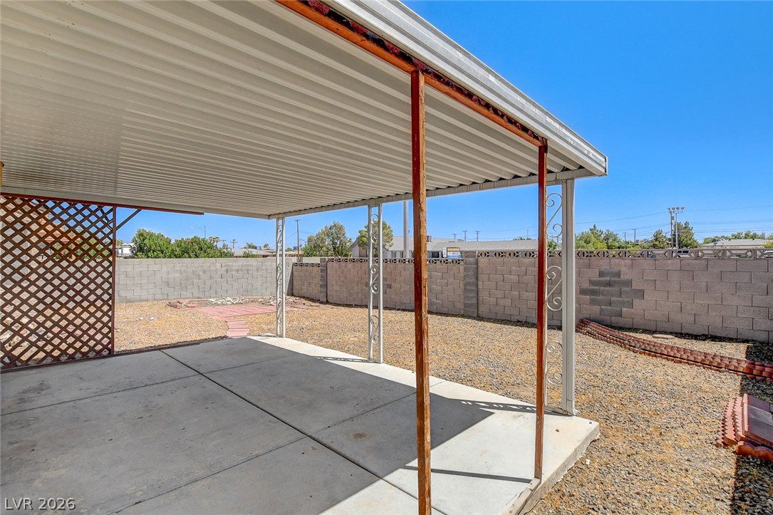 6209 Warm River Road Las Vegas, NV 89108 - Photo 36 of 39 A spacious covered patio extends to a fenced backyard, ideal for outdoor leisure.