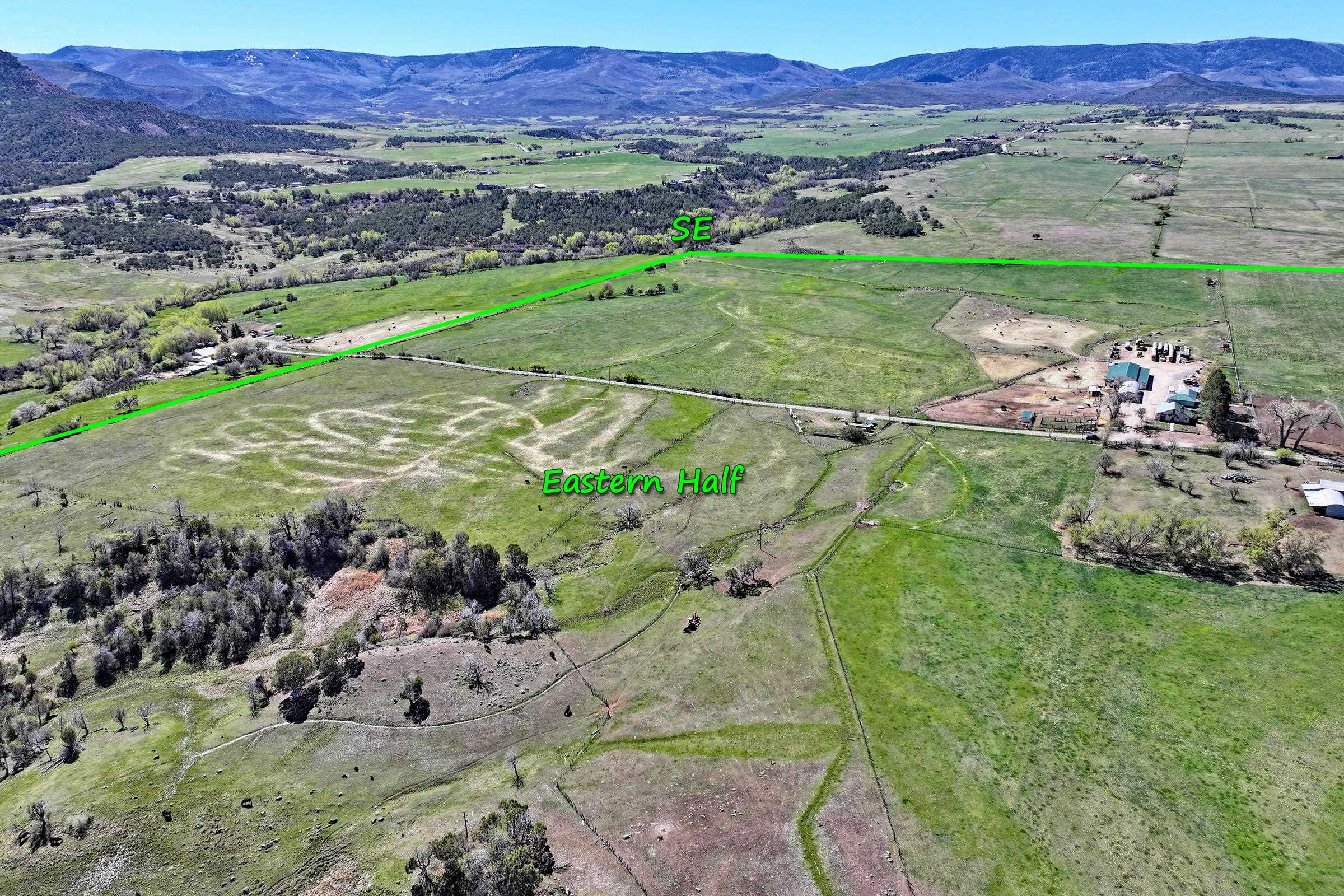 58749 Oe Road Collbran, CO 81624 - Photo 38 of 42 a view of a lush green hillside and houses