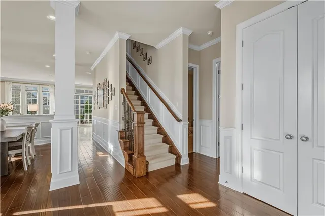 a view of entryway and hall with wooden floor