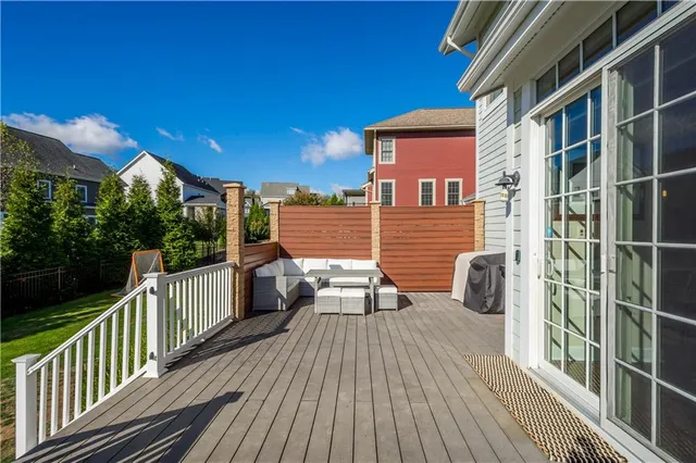 a view of a balcony with wooden floor and fence