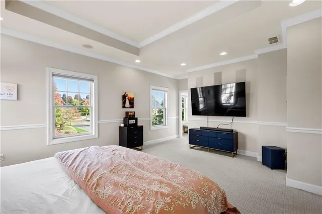 a bedroom with a bed and a flat screen television