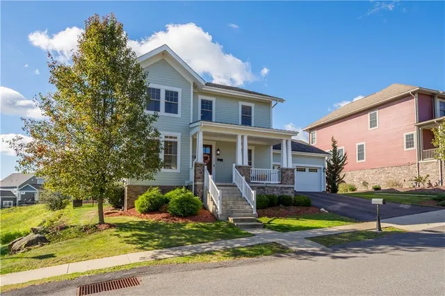 a front view of house with yard and green space