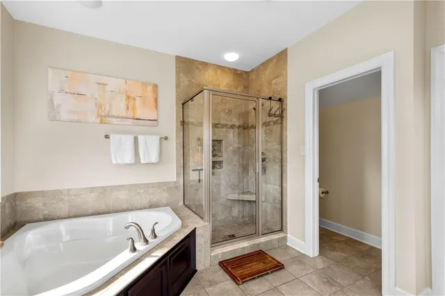 a bathroom with a bathtub and a shower