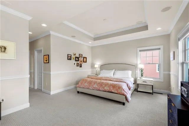 a spacious bedroom with a bed and a window