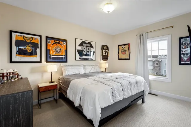 a bedroom with a bed and wall painting