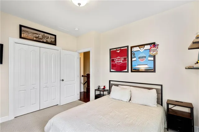 a bedroom with a bed and a painting on the wall