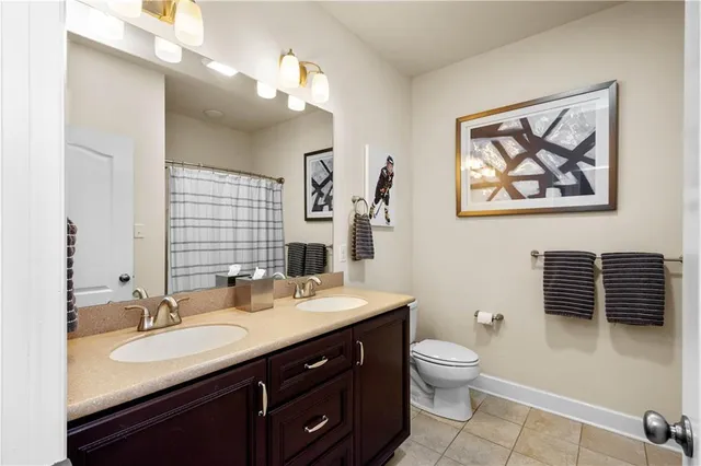 a bathroom with a toilet a sink and mirror