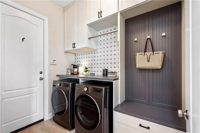 a view of a hallway with washer and dryer