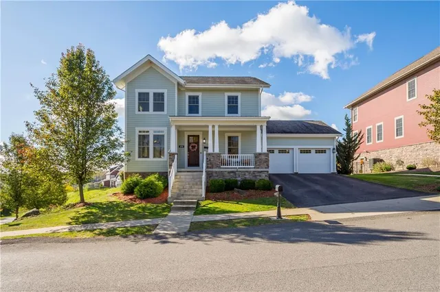 a view of a house with a big yard and large trees