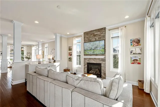 a living room with furniture fireplace and wooden floor