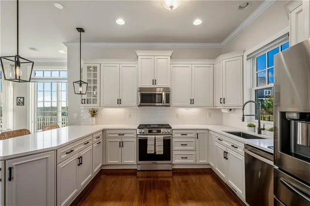 a kitchen with stainless steel appliances granite countertop a stove sink and cabinets