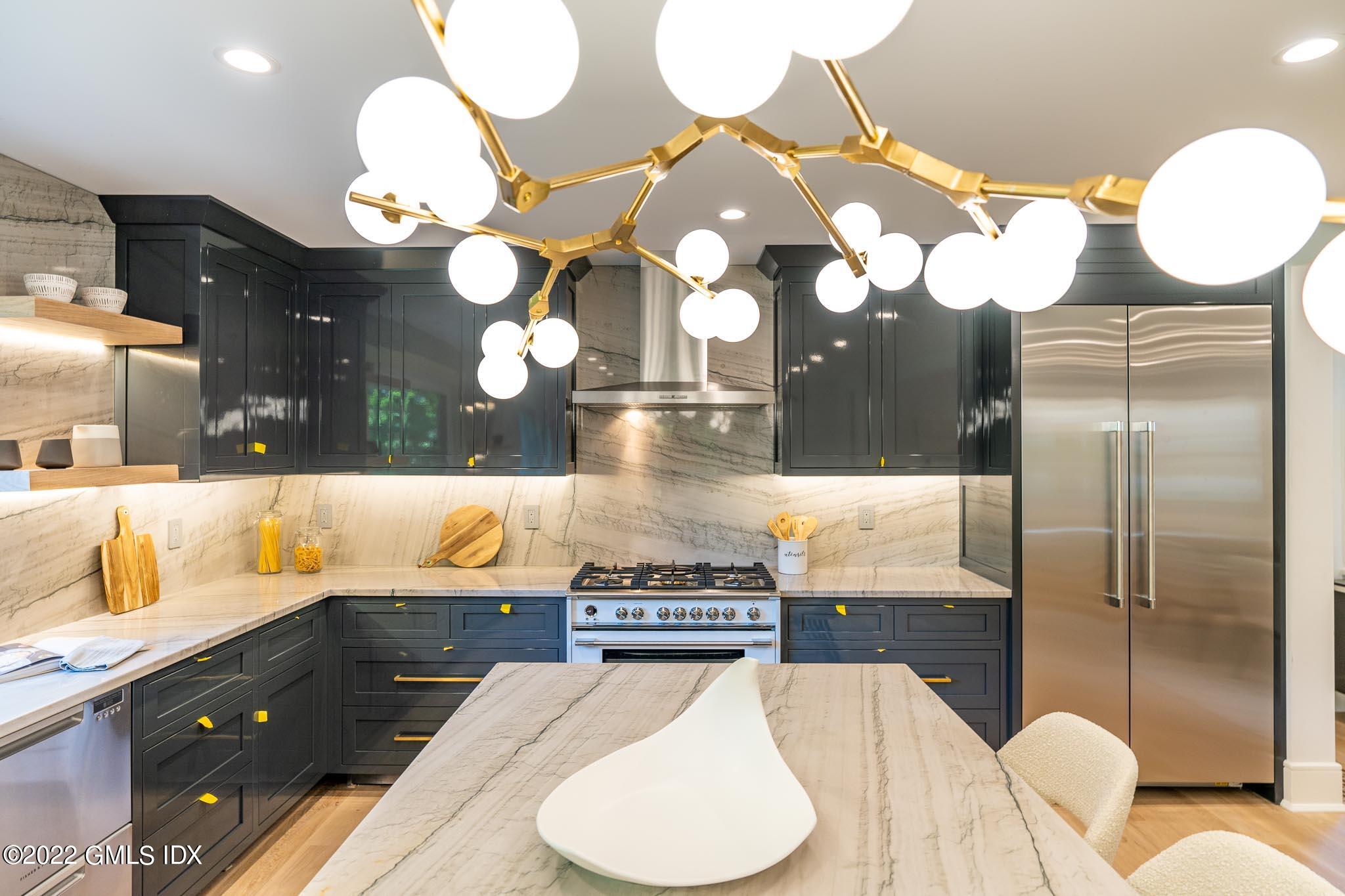 40 Halsey Drive Old Greenwich, CT 06870 - Photo 12 of 40 a kitchen with a chandelier a sink and a stove