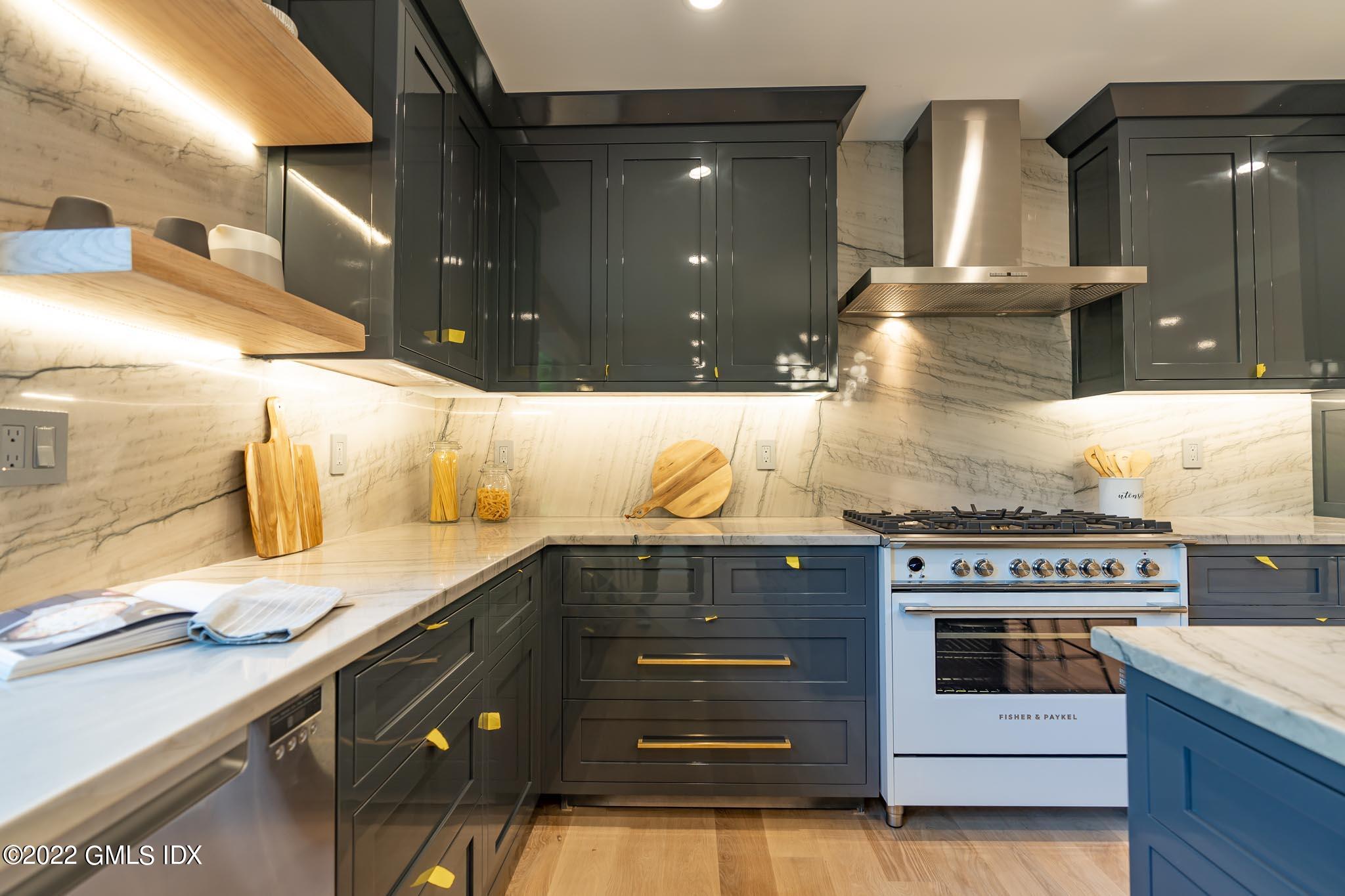 40 Halsey Drive Old Greenwich, CT 06870 - Photo 13 of 40 a kitchen with a stove and cabinets