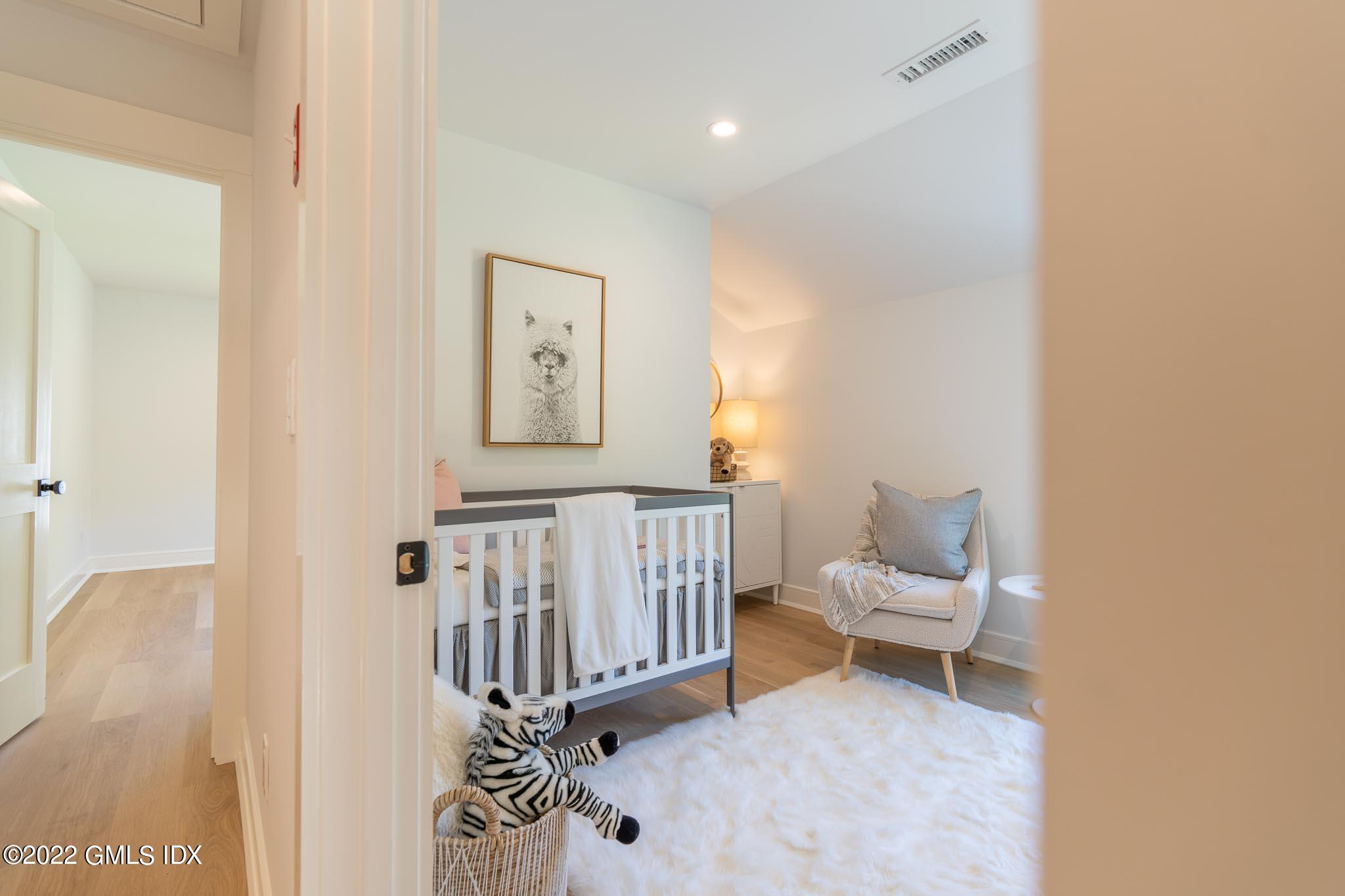 40 Halsey Drive Old Greenwich, CT 06870 - Photo 26 of 40 a living room with a baby crib furniture and a window