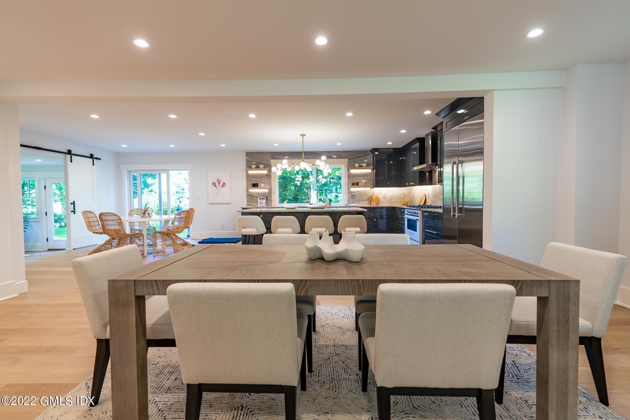 40 Halsey Drive Old Greenwich, CT 06870 - Photo 6 of 40 a dining area with a table chairs and a kitchen view