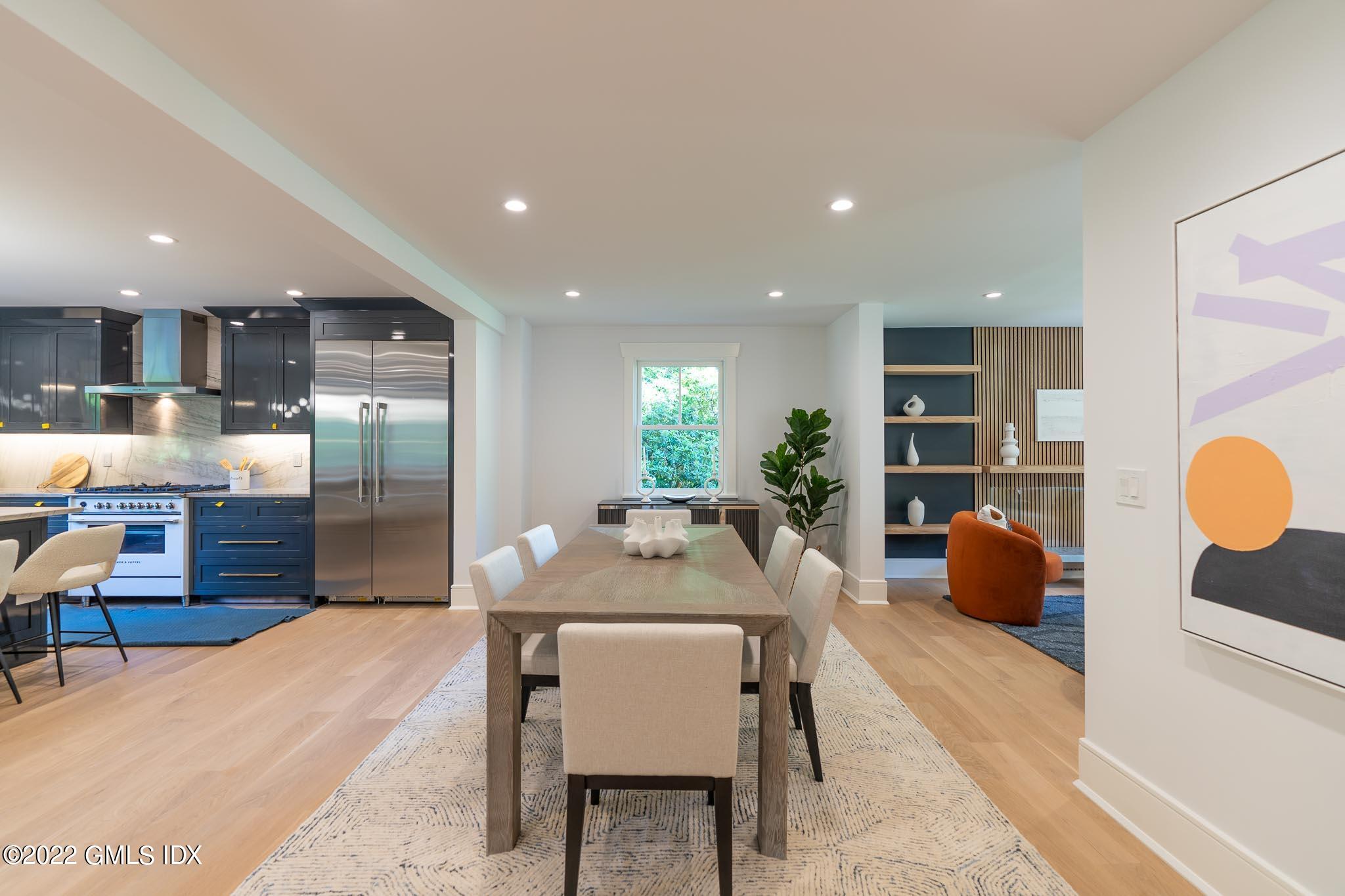 40 Halsey Drive Old Greenwich, CT 06870 - Photo 8 of 40 a kitchen with stainless steel appliances kitchen island granite countertop a refrigerator a stove a sink with dining table and chairs