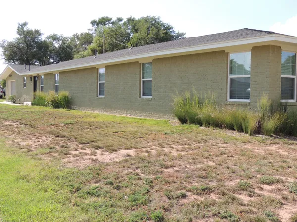 a view of a backyard of the house