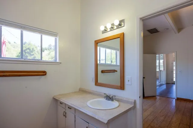 a bathroom with a sink a toilet and a mirror