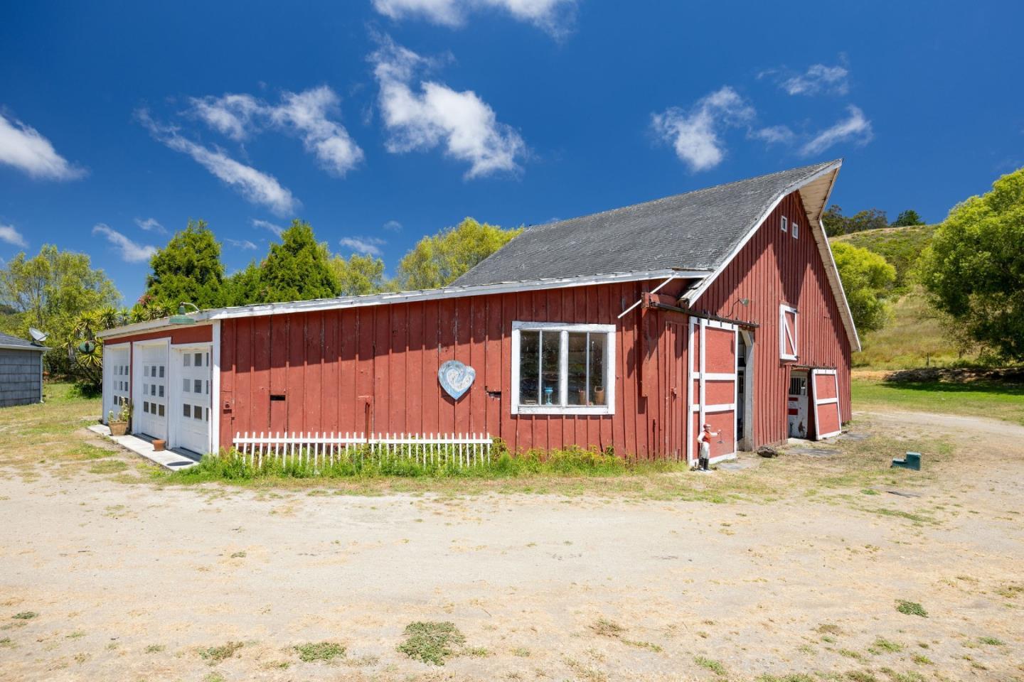 1650 Stage Road Pescadero, CA 94060 - Photo 29 of 55 a front view of a house with a yard and garage