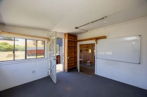 a kitchen with cabinets and wooden floor