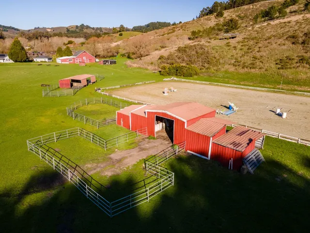 an aerial view of residential houses with outdoor space