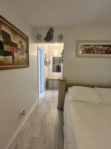 a bed room with a bed and a large mirror