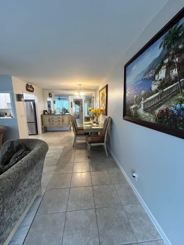 a living room with furniture and painting on the wall