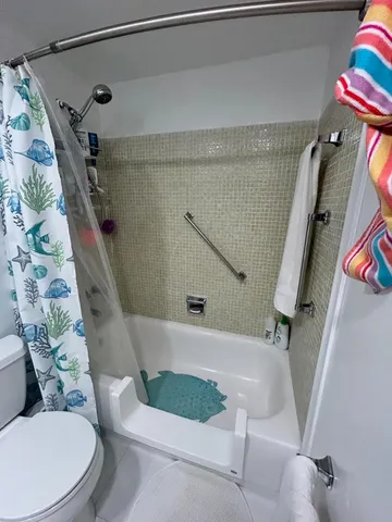 a bathroom with a toilet and a shower
