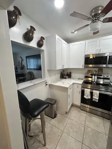 a kitchen with a sink cabinets and window