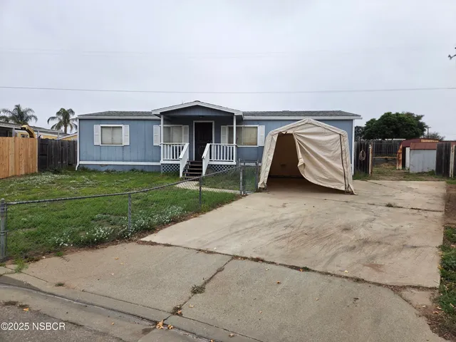 a view of a house with backyard and deck