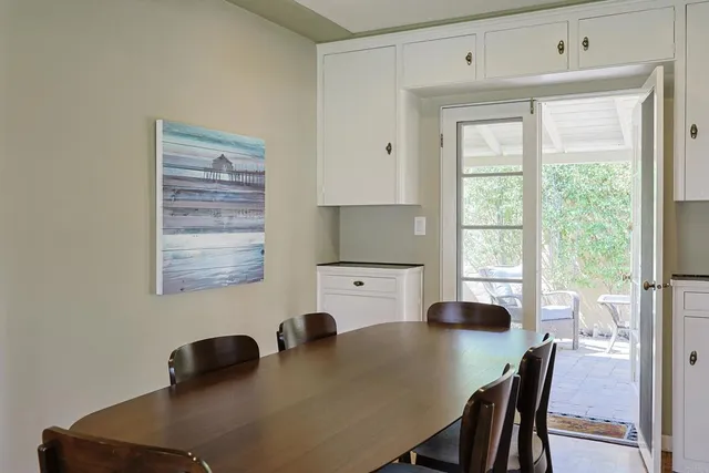 a view of a dining room with a table and chairs