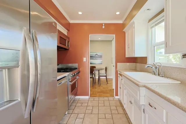 a view of a patio with table and chairs and potted plants