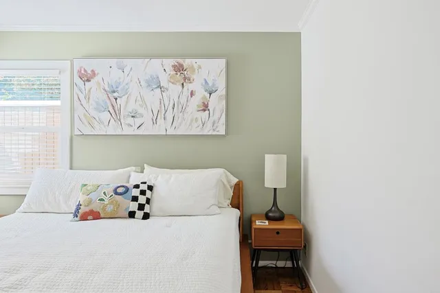a white couch sitting next to a white cabinet