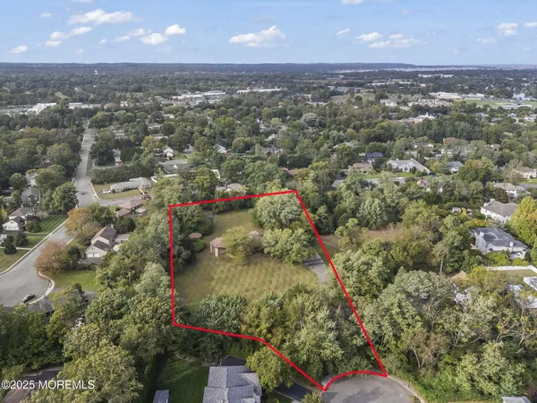an aerial view of a houses with a yard
