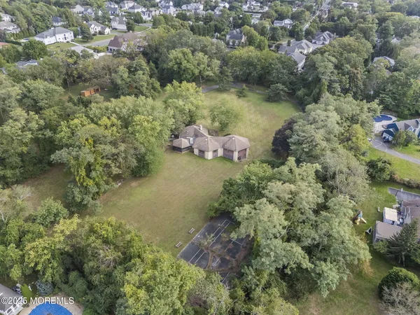 an aerial view of a house with a yard