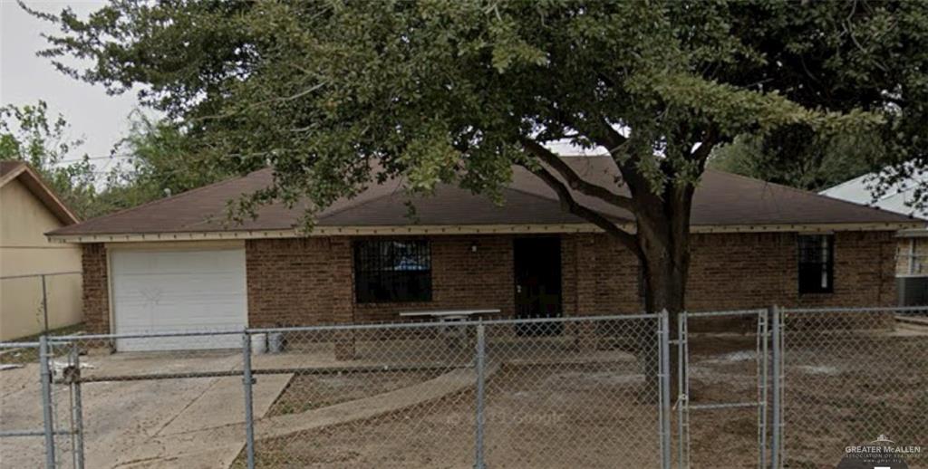 2903 Loma Linda Circle Palmview, TX 78572 - Photo 1 of 8 Ranch-style house featuring brick siding, concrete driveway, fence, and a garage