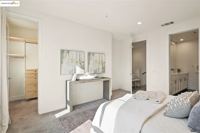 a room with a bed and a view of kitchen