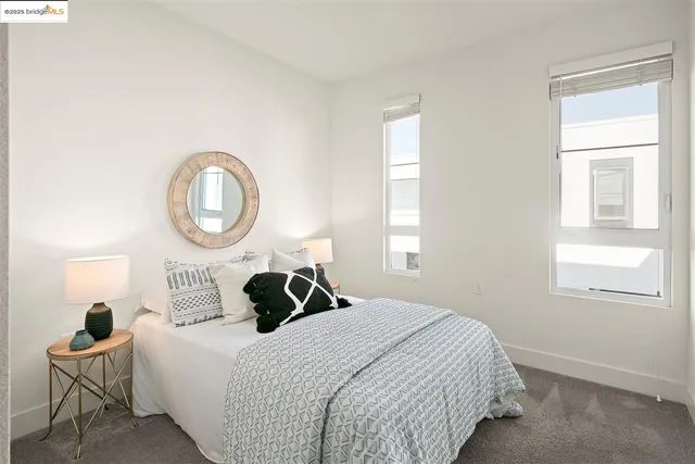 a bedroom with a bed chair and a window