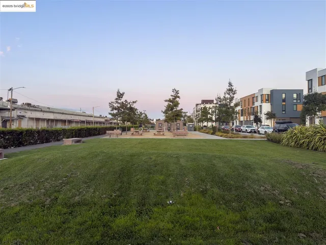 a view of a big building with a big yard and large trees