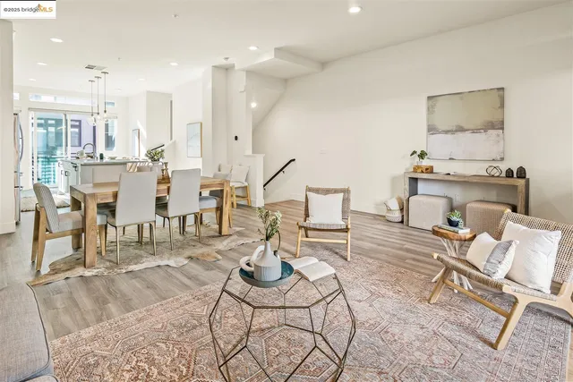 a living room with furniture and kitchen view
