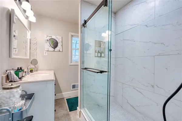 a bathroom with a sink toilet and shower