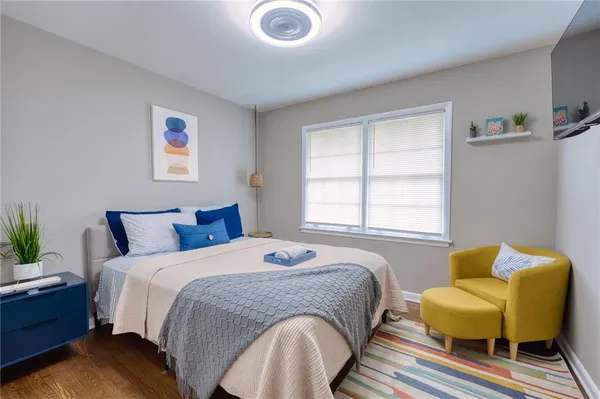 a spacious bedroom with a bed and a couch