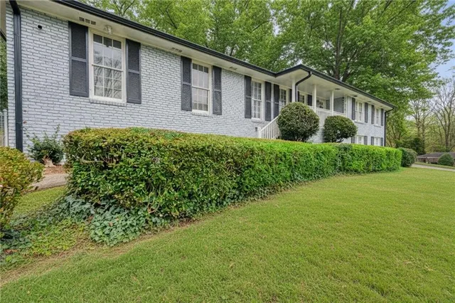 a front view of a house with a garden