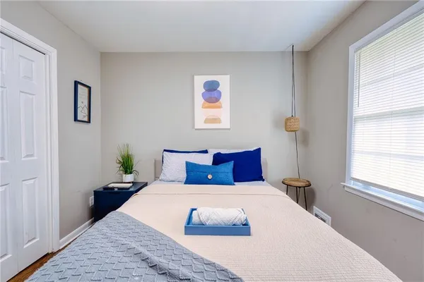 a bedroom with a large bed and a window