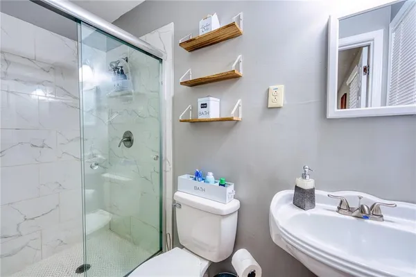 a bathroom with a sink toilet and shower