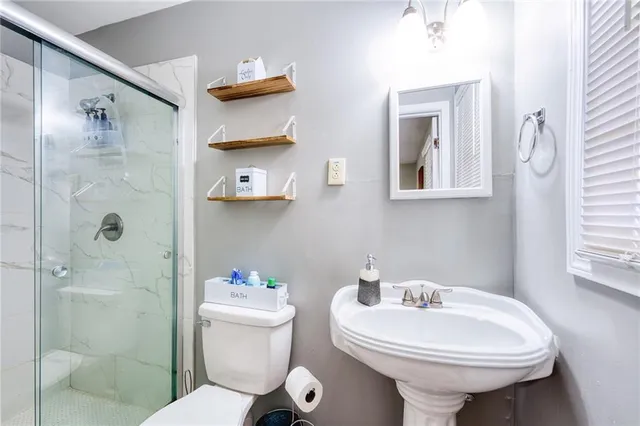 a bathroom with a sink toilet and shower