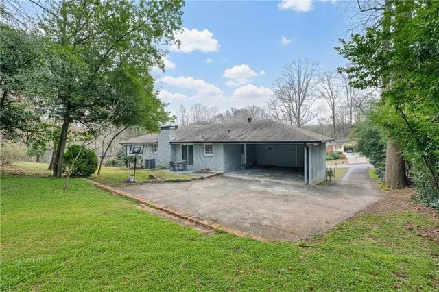 a front view of house with yard and green space