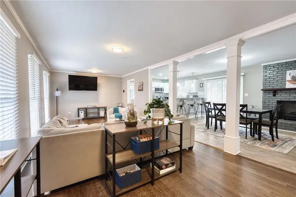 a view of a dining room with furniture window and wooden floor